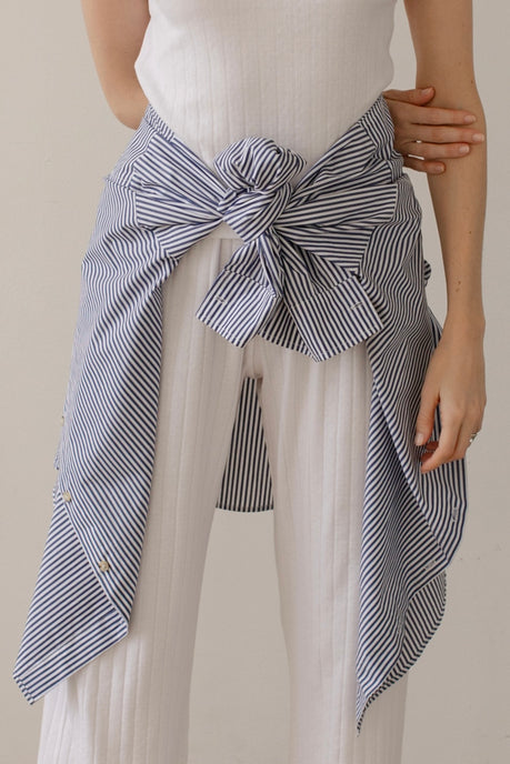 This is a close-up of the white Pointelle Square Neck Tank, matching white Pointelle Simple Crop Pant, and The Pop Button Down shirt tied at the waist.
