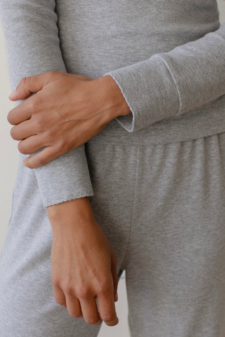 A close up of The Jersey Long Sleeve Tee in grey with the grey Baby Rib Scallop Pant.